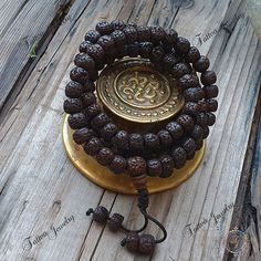 "This attractive and powerful Japa Mala is made with Rudraksha bead that are naturally stained and oiled to achieve their beautiful dark color and aged appearance.  📿Mala Beads, or Buddhist prayer beads, are a set of sacred rosary beads for chanting & counting mantras, meditation, prayer, yoga & reflection. Mala is a Sanskrit word meaning garland. The Tibetan word for mala is threngwa (Tibetan  ཕྲེང་བ) . Seed malas are some of the most common malas used in Tibet and Nepal. Buddhist Prayer Beads are sometimes referred to as Japa mala, japa is a Sanskrit word meaning \"repeat internally\".📿 Specifications  * 108 Rudraksha Seed (9-9.5mm approx.) soaked in oil to get darker color plus 14mm Guru Bead  * This mala is hand strung on durable knotting cord * Fixed knot closure * Total Mala Length Adjustable Spiritual Mala With 8mm Beads, 108 Beads For Festivals, Spiritual Mala For Festival Occasions, Adjustable 8mm Beads For Puja, Traditional Black Mala With 108 Beads, Spiritual Black Beads Mala For Meditation, Adjustable Spiritual Mala For Festivals, Adjustable Mala With 8mm Beads For Puja, Spiritual Brown Mala For Festivals