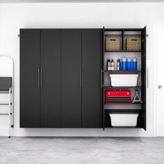 a kitchen with black cabinets and white walls