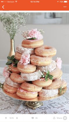 a large stack of doughnuts sitting on top of a table