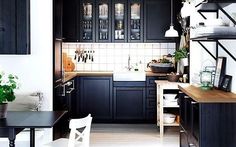 the kitchen is clean and ready for us to use it's dark wood cabinets