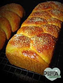 several loaves of bread sitting on top of a cooling rack with powdered sugar sprinkled on them