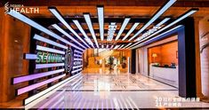 the entrance to an office building is lit up with colorful lights and letters that spell out health