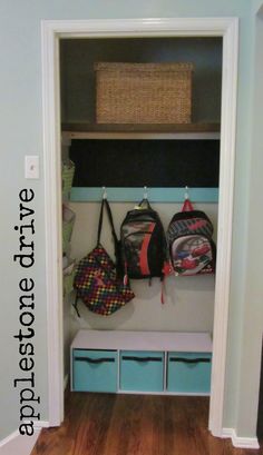 an entryway with several bags and bins on the shelf, along with baskets