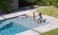 two children playing in the pool with toys