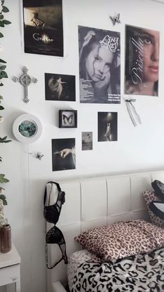 a bedroom with posters on the wall and pictures on the wall above the headboard