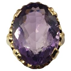 Vintage 14K Yellow Gold Amethyst Ring Size 6.75 JAGi Certified- This elegant ring features one oval cut amethyst (17.8 mm x 13.1 mm)set in beautifully detailed 14K yellow gold. Width: 19.8 mm. Shank: 2.2 mm. Amethyst weight: 10.0 ct. Ring size: 6.75 Stamped: 14K Weight: 6.0 gr./ 3.9 dwt. JAGi Certificate included. Very good condition, professionally polished. Will come packaged in a gift box or pouch (when possible) and will be shipped U.S. Priority Mail Insured. DV100923/17KCS