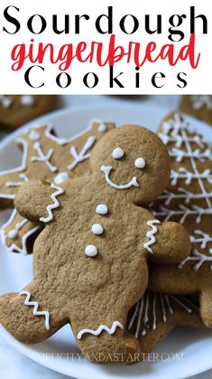 gingerbread cookies with white icing and sprinkles are on a plate