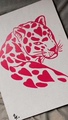 a red and white drawing of a cheetah sitting on top of a sheet