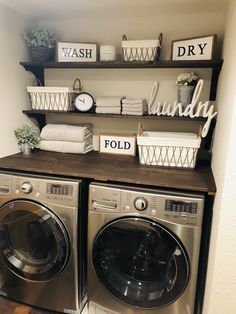 a washer and dryer sitting next to each other on top of a wooden shelf