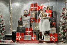 a christmas display with presents and mannequins