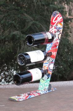 three wine bottles are stacked in the shape of a snowboard