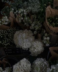 white flowers and greenery are on display for sale