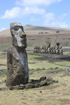 a large stone statue sitting in the middle of a field