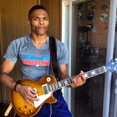 a man holding an electric guitar in his hands