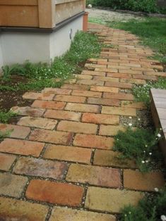 an old brick path leading to a house