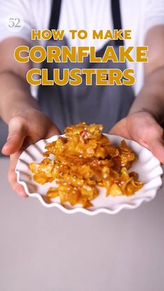 a person holding a paper plate with cornflake clusters on it and the words, how to make cornflake clusters