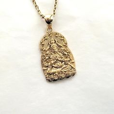 women's and men's buddha necklace pendant 2 L 29mm made in real 14k solid gold or real 18k solid gold avalokitesvara is a bodhisattva who embodies the compassion of all buddhas. - this buddha pendant height is L 29.0mm without the bail. - the buddha necklace pendant 2 M 24.5mm and L 29.0mm are on our store. - model wears a 2.1mm 50cm chain. - materials: real 14k solid gold, real 18k solid gold - free shipping on all orders via fedex - made in south korea 14k gold buddha pendant necklace 2 L weight pendant only 9.37g (±3%) with a 2.1mm 42cm chain 15.33g (±3%) with a 2.4mm 42cm chain 17.20g (±3%) with a 3.0mm 42cm chain 20.95g (±3%) 18k gold buddha pendant necklace 2 L weight pendant only 11.17g (±3%) with a 2.1mm 42cm chain 17.57g (±3%) with a 2.4mm 42cm chain 19.58g (±3%) with a 3.0mm 42cm Buddha Pendant Necklace, Gold Buddha, Buddha Necklace, Necklace Men, Buddha Pendant, Mens Pendant, Pendant Gold, Men Necklace, Necklace Pendant