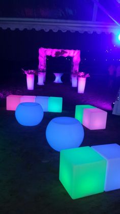 an outdoor event with glowing furniture and lights