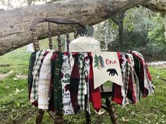 an old chair is decorated with plaid and bear themed fabric for the tablecloths