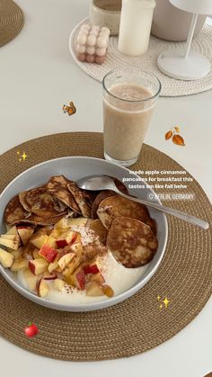 a plate with pancakes, fruit and yogurt next to a glass of milk