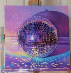 a painting of a disco ball on an easel in front of a purple background