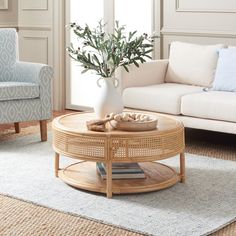 a living room filled with furniture and a white vase on top of a coffee table