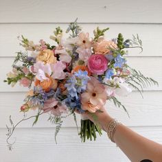 a person holding a bouquet of flowers in their hand