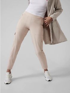 Athleta Chelsea Cargo Lined Pant, Abalone Grey, Size 12P(Petite), #631619, NWT $98.00 FIT & SIZING     Semi"fitted, skims easily over the body with a mid"rise waistband     Fits slim through the leg then eases up below the knee     Inseam: Reg 28.5"; Petite 26.5"; Tall 31.5" PRODUCT DETAILS     FOR: Commuting, work, and travel     FEEL: Featherweight Stretch lined with soft jersey to keep cozy and warm     FAVE: 6 pockets: 4 secure zip and 2 cargo     Flat front waistband with elastic in back     Easy style with versatile styling     #631619     Fabric:     Recycled Polyester/Spandex     BREATHABLE: Airflow moves easily through the garment     ABRASION"RESISTANT: Resists snags and tears     WRINKLE"RESISTANT: Packable fabric that airs wrinkles out easily     QUICK"DRYING: Dries in a flash Neutral Pants, Work And Travel, Travel Pants, Easy Style, Cargo Pant, Athleta Pants, Straight Leg Pants, Girls Shopping, Track Pants