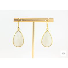 Indulge in luxury with these stunning drop earrings. The vermeil bezel perfectly captures the large shimmering white moonstone, giving off a gorgeous and luminous effect. Elevate any outfit with these elegant and exclusive earrings. Stunning, sparkling, faceted white moonstones set in vermeil bezels. Gold-plated lever backs for a secure and comfortable fit. 1.75 inches long Limited edition, only two pairs available. Elegant Gold Crystal Earrings With Moonstone, Elegant White Moonstone Crystal Earrings, Gold Moonstone Drop Crystal Earrings, Gold Moonstone Drop Earrings, White Moonstone Drop Earrings, Exclusive Earrings, White Statement Earrings, Moonstone Drop Earrings, Artisan Rings