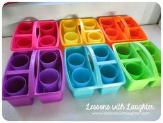 there are many different colored plastic containers on the table