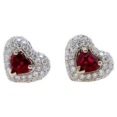 This gorgeous pair of heart shaped rubies are set in a custom made 18k white gold diamond setting. The heart shaped frame further accentuates the beautiful heart shaped rubies. Definitely different than your classic studs, that will grasp everyone's attention! Stone: Ruby 1.50 cts, Heart Shape Diamonds: 1.12 cts, Round Brilliant Metal 18k White gold Elegant Heart Cut Ruby Jewelry, Luxury Heart-shaped Brilliant Cut Earrings, Luxury Heart-shaped Diamond Cut Earrings, Diamond White Heart-shaped Diamond Earrings, Fine Ruby Heart-shaped Jewelry, Heart Shaped Diamond Earrings, Baguette Diamond Earrings, Ruby Stud Earrings, Ruby Earrings Studs