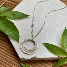 This elegant necklace offers up a unique combination of playfulness & timeless style. Nine organically shaped & uniquely textured sterling silver circles layer gracefully on a lovely sterling silver double cable chain. Each ring is handcrafted individually to represent your journey through the decades. Circles are hammered flat & strong, and given a rustic sparkly texture. The circles shimmer & move gracefully with you, capturing the light & landing in various arrays. This piece is a beautiful w Adjustable Necklace For Gift, Adjustable Spiral Jewelry With Oxidized Finish, Modern Silver Birthstone Necklaces, Modern Silver Birthstone Necklace, Hammered Spiritual Necklaces With Adjustable Fit, Spiritual Hammered Adjustable Necklace, Adjustable Hammered Spiritual Necklaces, Silver Fusion Necklace For Anniversary, Silver Fusion Style Necklace For Anniversary