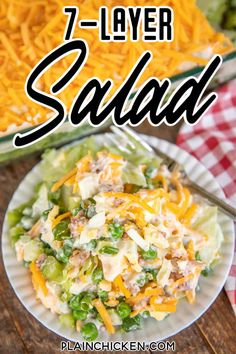 a salad on a plate with cheese and green onions in the background text overlay reads 7 - layer salad