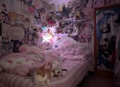 two cats laying on top of a bed in a room with lots of wallpaper