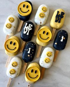 an assortment of smiley face pops on sticks