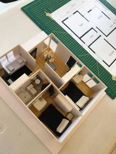 an overhead view of a model house with the floor plan cut out and ready to be built