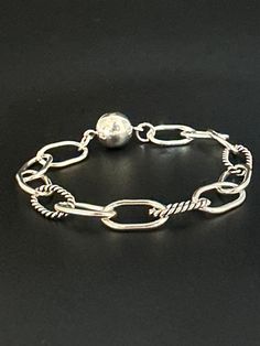 The Maddie Bracelet - Silver chain link chunky textured bracelet measures 7 inches with a unique ball clasp. Ball charm closes to secure hook. Y2K grunge style is so aesthetic 🤍 Check out more listings in my shop xoxo https://www.etsy.com/shop/JennissiJewelry Handmade Adjustable Chain Link Bracelets, Handmade Adjustable Oval Link Chain Bracelet, Adjustable Metal Charm Bracelet With Oval Link, Handmade Adjustable Chain Link Bracelet, Chunky Silver Chain Bracelet, Adjustable Chunky Chain Bracelet, Adjustable Metal Charm Bracelet With Chunky Chain, Adjustable Silver Charm Bracelet With Chunky Chain, Adjustable Chunky Chain Charm Bracelet