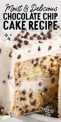 a close up of a cake with white frosting and chocolate chips on the top