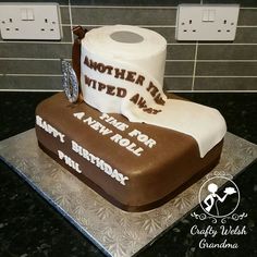 a birthday cake made to look like a roll of toilet paper