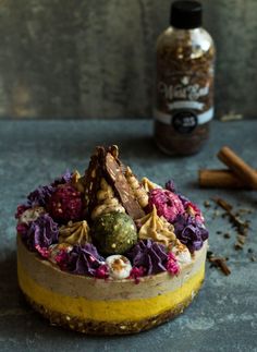 a cake sitting on top of a table next to spices