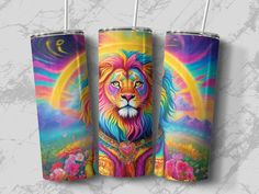 three colorful lion tumblers with straws in them on a marble surface, one has an image of the sun behind it