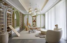 a child's room with green walls, white furniture and giraffes