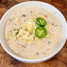 a white bowl filled with pasta and green peppers