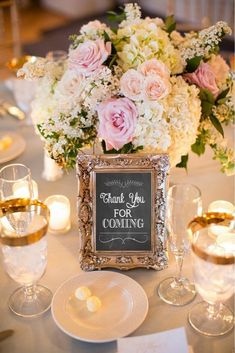 a table topped with white and pink flowers