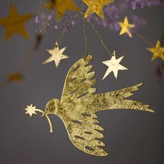 a golden bird hanging from a string with stars