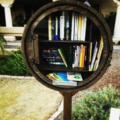 a mirror with books on it in front of a house