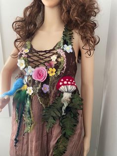 a mannequin wearing a dress with flowers and birds on it's chest