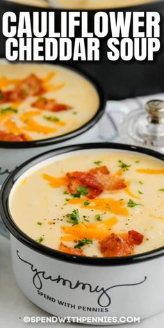 two bowls of cauliflower cheddar soup on a table