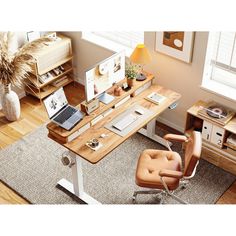 an overhead view of a desk with a laptop on it and a chair next to it