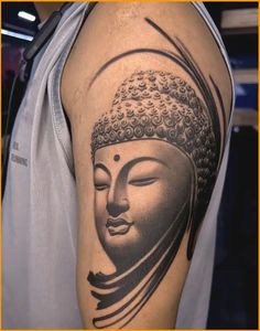 a man with a buddha tattoo on his arm